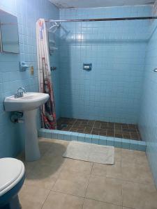 a bathroom with a toilet and a sink and a shower at Recamara a media cuadra de la playa in Mazatlán +7 photos