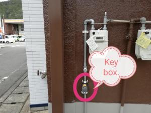 una caja de llaves en el lateral de un edificio en Noah House 102貸切, en Shingu