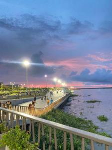 a pier with people walking on it next to the water at Casa Ciudad Jardin Centro Histórico in Barranquilla