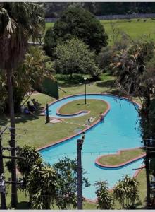 uma vista panorâmica de uma grande piscina num parque em Charmoso Apartamento Retrô no Hotel Quitandinha com vaga de garagem em Petrópolis