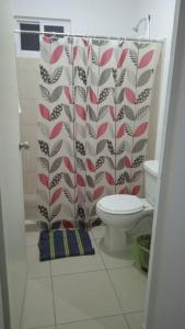 a bathroom with a toilet and a shower curtain at Yecapixtla in Yecapixtla