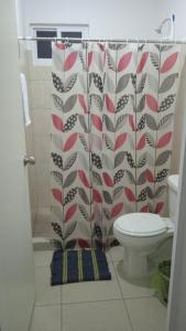 a bathroom with a shower curtain and a toilet at Yecapixtla in Yecapixtla