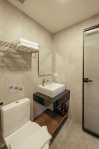 a bathroom with a white toilet and a sink at 參穗 SunSui B&B in Dongshan