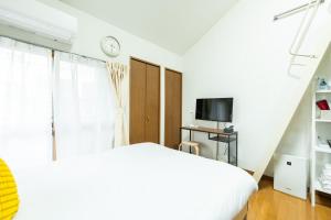 Katil atau katil-katil dalam bilik di Rooms箱崎