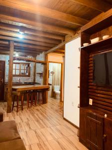 Il comprend un salon doté d'une table à manger et d'une télévision. dans l'établissement Casa de aluguel praia do rosa, à Garopaba