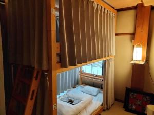 a bedroom with a bunk bed in a room at Magome Chaya in Nakatsugawa