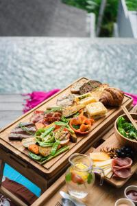a wooden table with a tray of food on it at LeRosa Valley Resort in Ubud