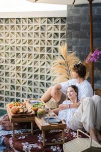 a man and a woman sitting on a couch at LeRosa Valley Resort in Ubud