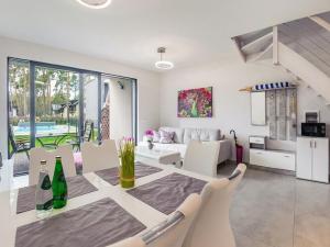 a dining room and living room with a table and chairs at 2-level apartment, pool, Pobierowo in Pobierowo