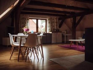 a room with a table and chairs and a kitchen at Apartment in Gronowo near Lake Siecino in Gronowo
