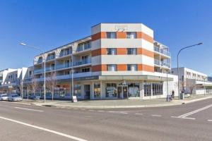 un edificio all'angolo di una strada cittadina di 2BR Apt Gungahlin Square Luxe Super Central Wifi Wine Secure Parking a Canberra