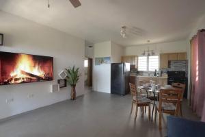 a living room with a table and a fire in the wall at Sunset Seclusion. in The Valley