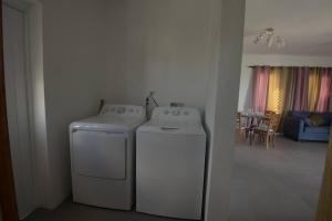 a room with a washer and dryer in a house at Sunset Seclusion. in The Valley