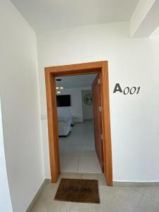 a hallway with an open door to a room at Vista Golf II Playa Nueva Romana in San Pedro de Macorís