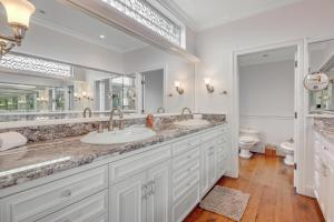 a bathroom with two sinks and a large mirror at Perched on the Bluff - Main Home in Mendocino +29 photos