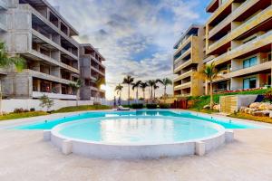 a large swimming pool in front of a building at Beautiful Casita Vista Velas 8303 in Cabo San Lucas