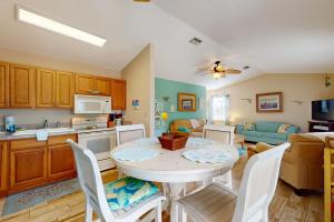 a kitchen and living room with a table and chairs at Salt, Sand, Sea in North Port