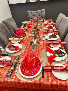 a red table with plates of food on it at Tree Aloe Guest house in St Francis Bay