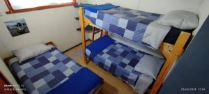a bedroom with two bunk beds in a room at Cabañas Lican Ray centro a pasos de la playa - Loica in Licán Ray