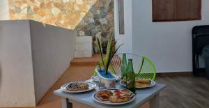 a table with plates of food and drinks on it at La Conchita de Sisal 2 in Sisal