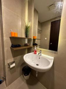 a bathroom with a sink and a mirror at LUXURY CASA DE PARCO Apartment Near AEON MALL, THE BREEZE, ICE BSD in Tangerang