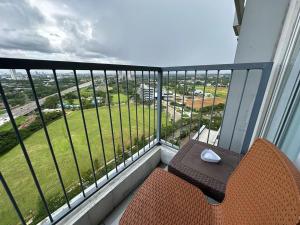 a balcony with a table and a view of a field at LUXURY CASA DE PARCO Apartment Near AEON MALL, THE BREEZE, ICE BSD in Tangerang