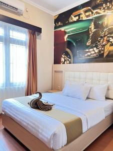 Voodi või voodid majutusasutuse Ayuri Hotel Malioboro toas