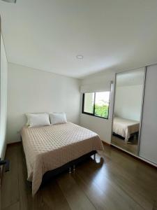 a bedroom with a bed and a large mirror at Phantom Departamento de Lujo a estrenar in Santa Cruz de la Sierra +19 photos