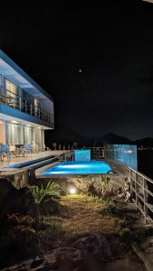 a house with a swimming pool at night at Serenity Inn Los Chimus in Tortuga