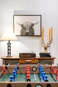 a table with a chess board with a picture of a cow at The Lodge, 'North Woods' style, boutique Galena Getaway! in Galena