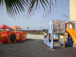 a bunch of playground equipment in a parking lot at Appartamento Marina in Marina di Carrara