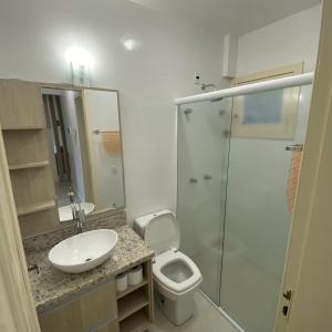 a bathroom with a sink and a toilet and a shower at Pousada Villa Koller in Marcelino Ramos