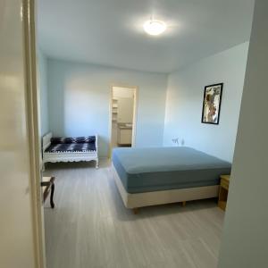 a small room with a bed and a bathroom at Pousada Villa Koller in Marcelino Ramos