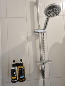 a shower with two shampoo bottles in a bathroom at Cozy, spacious and well located apartment in Guatemala