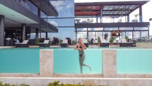 a woman standing in the water in a swimming pool at Vivanti Resort in Guatapé