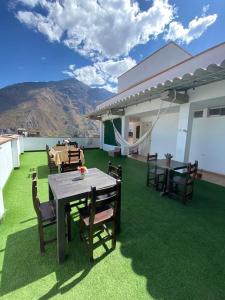 a patio with a table and chairs on a lawn at Hotel Sol de Canta in Canta