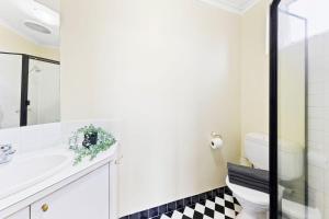 a bathroom with a white toilet and a sink at A Comfy & Cozy Apt in Clifton Hill FREE Parking in Melbourne