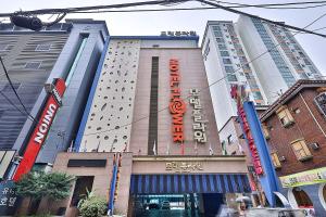 a building with a sign on the side of it at Flower Hotel in Seoul