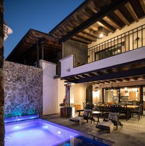 an outdoor patio with a swimming pool and a house at Private Jacuzzi & Pool, Elegant La Escondida 5BR in San Miguel de Allende