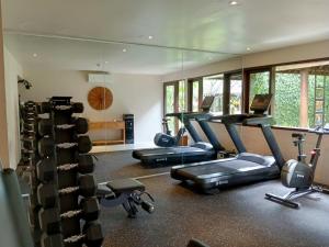 a gym with several treadmills and cardio machines at Villa Air Bali Boutique Resort and Spa in Seminyak