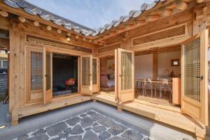 Gongju的住宿－Hongsi Art House，木墙和窗户以及用餐室。