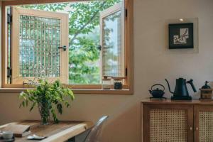 a kitchen with a table with a plant on it at Hongsi Art House in Gongju