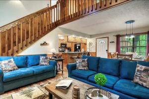 a living room with a blue couch and a table at Beary Peaceful Smokies Retreat: Hot-Tub & Pools in Pigeon Forge