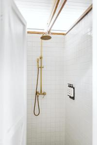 a bathroom with a shower with white tiles at The Woods Farm Jervis Bay in Tomerong