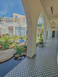 a walkway in a building with a pool of water at Barland Villa in Ke Ga