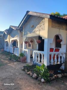 a house with baskets on the side of it at Hideout in Ukunda