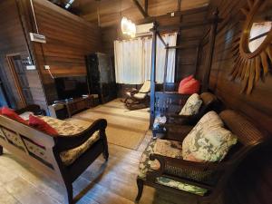 a living room with two chairs and a couch at Ombak Dive Resort Perhentian Island in Perhentian Islands