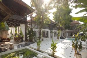 a courtyard of a house with a koi pond at Illui - Exclusive Estate in Chiang Mai - 8 Bedroom in Chiang Mai