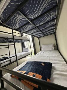 an upper bunk of a bunk bed in a room at GreenLake Vista in Surabaya