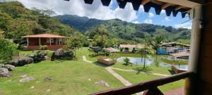 a view of a house with a view of a garden at Cabaña rodeada de naturaleza in Cocorná